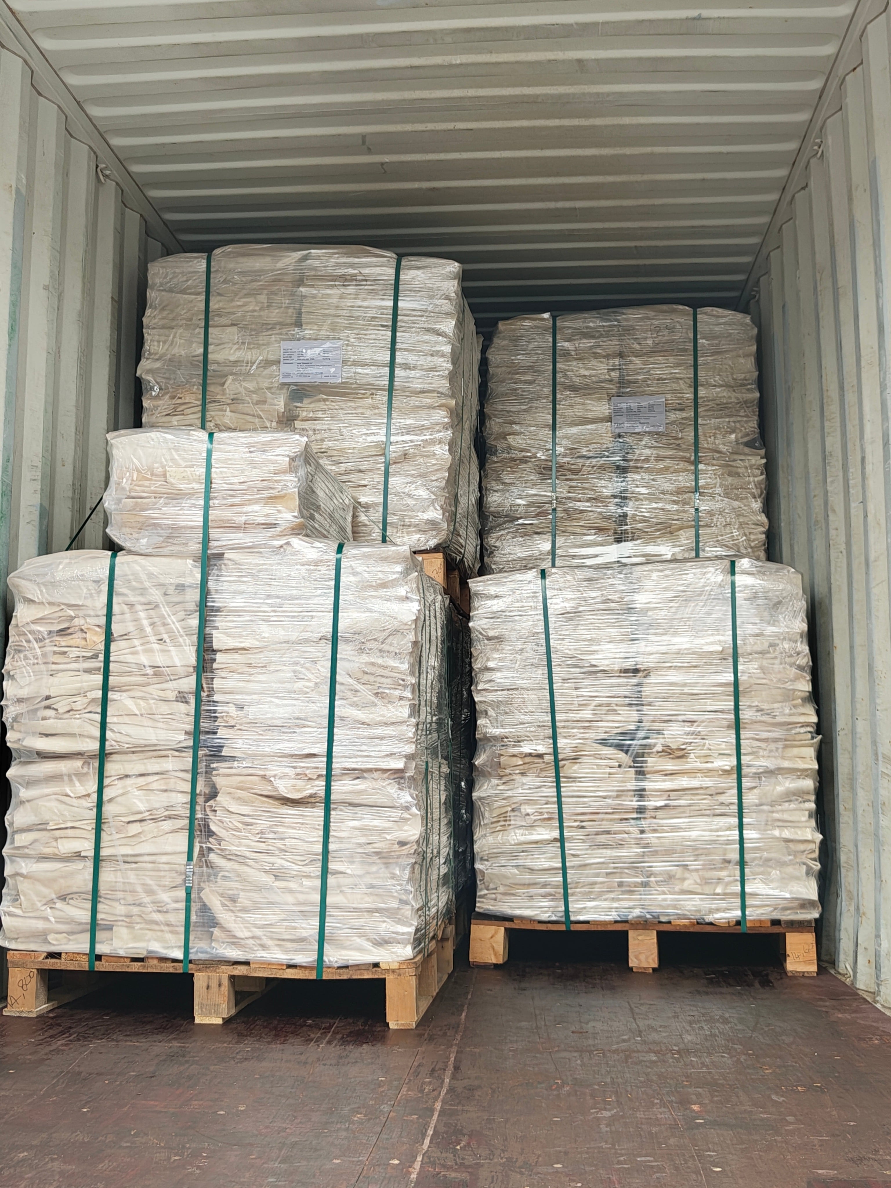 Palletized processed material prepared inside a shipping container